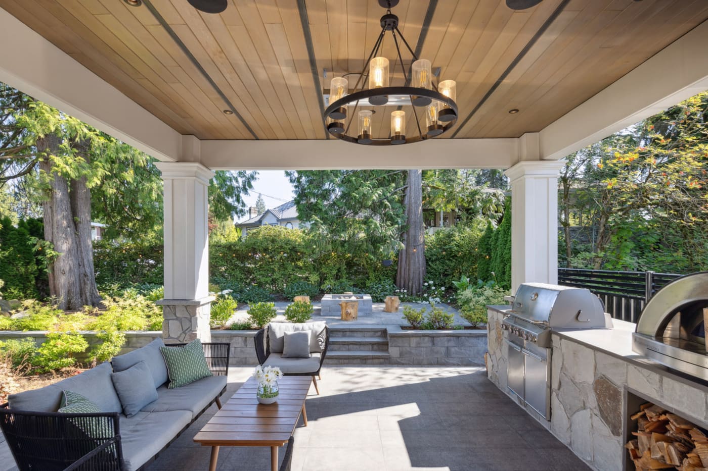 Covered patio with an outdoor kitchen and lounge seating