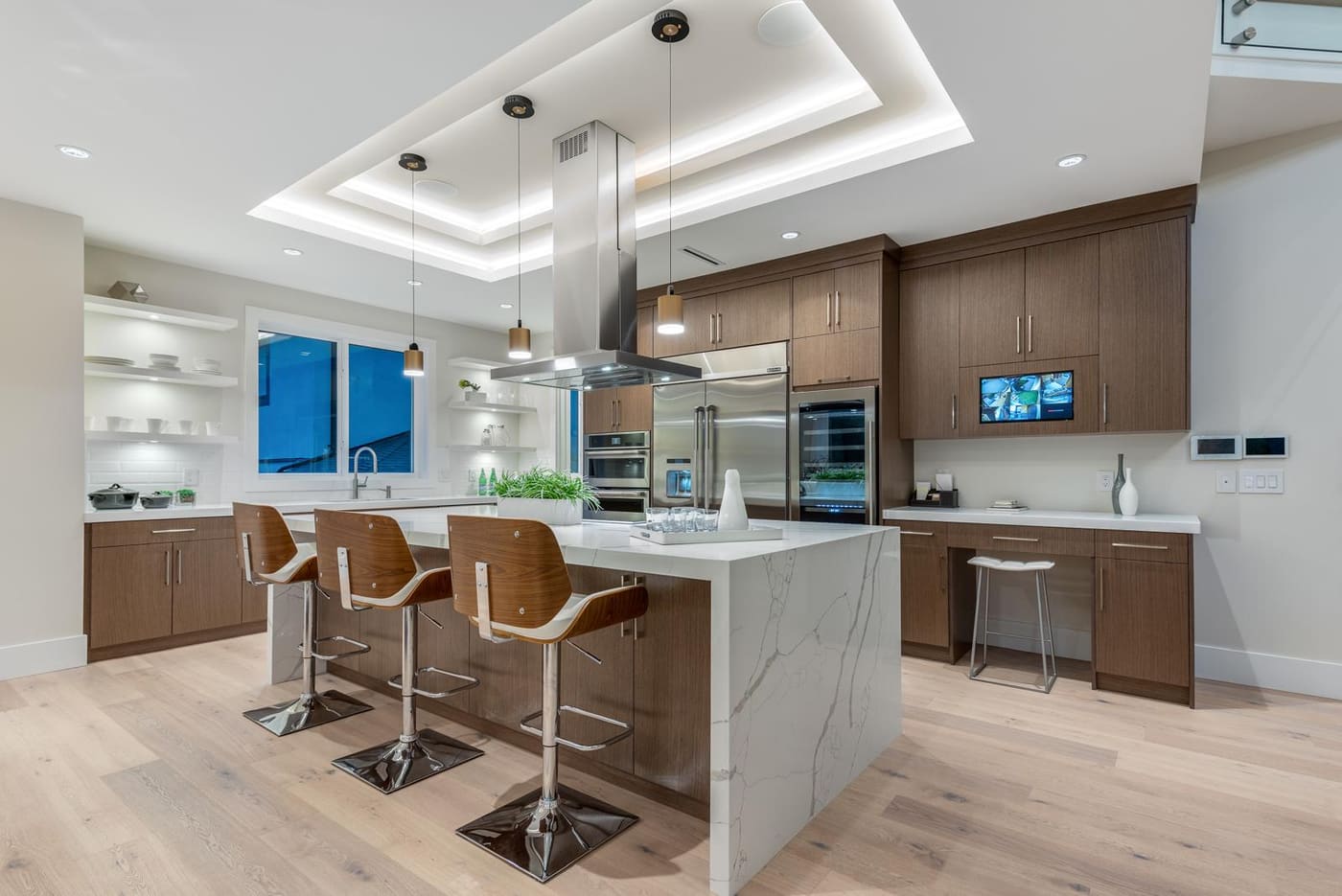 Kitchen island with a waterfall stone countertop and bar seating